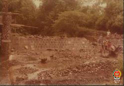 Tampak para pekerja sedang melakukan proses pemasangan batako di sisi sungai.